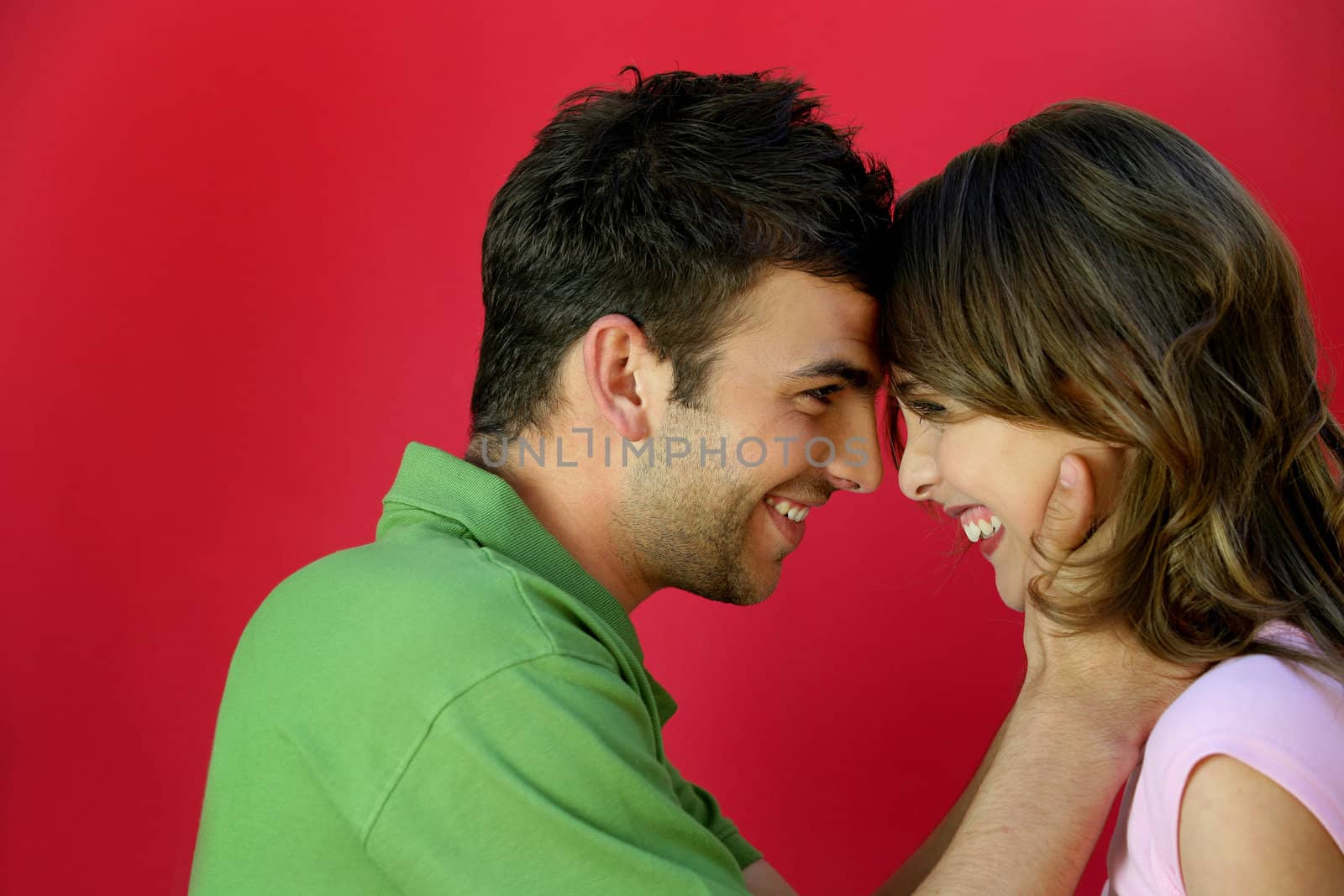 Affectionate couple stood facing each other by phovoir