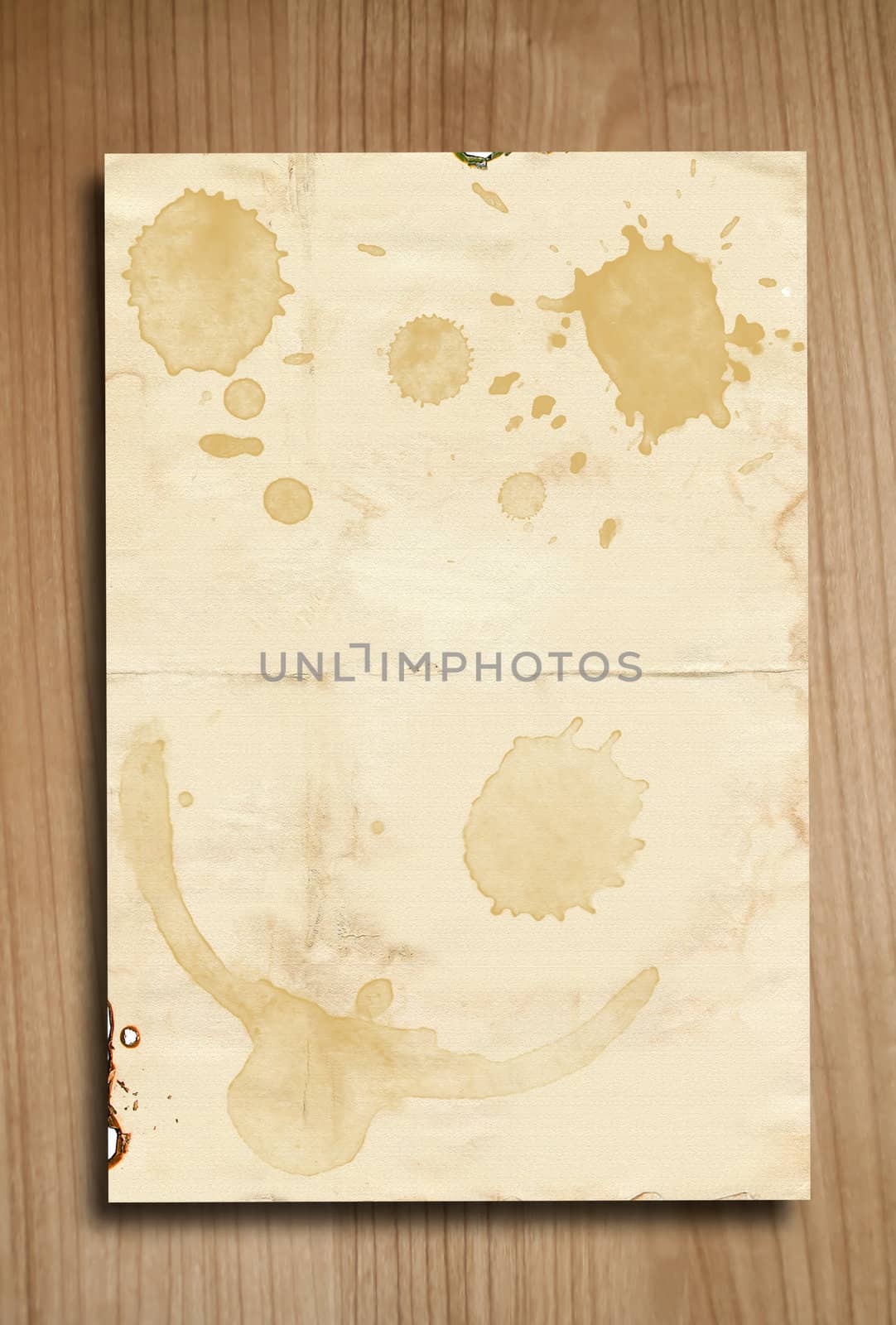 Vintage paper with coffee stains on wooden background 
 by rufous