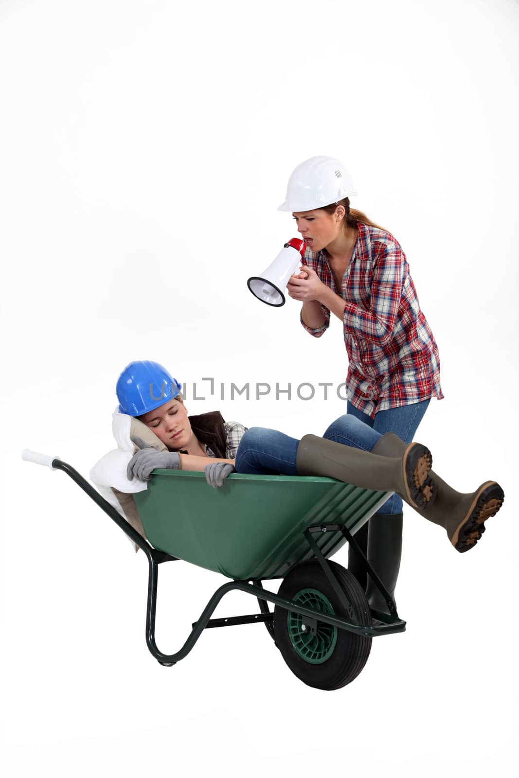 Woman with megaphone yelling at woman asleep by phovoir