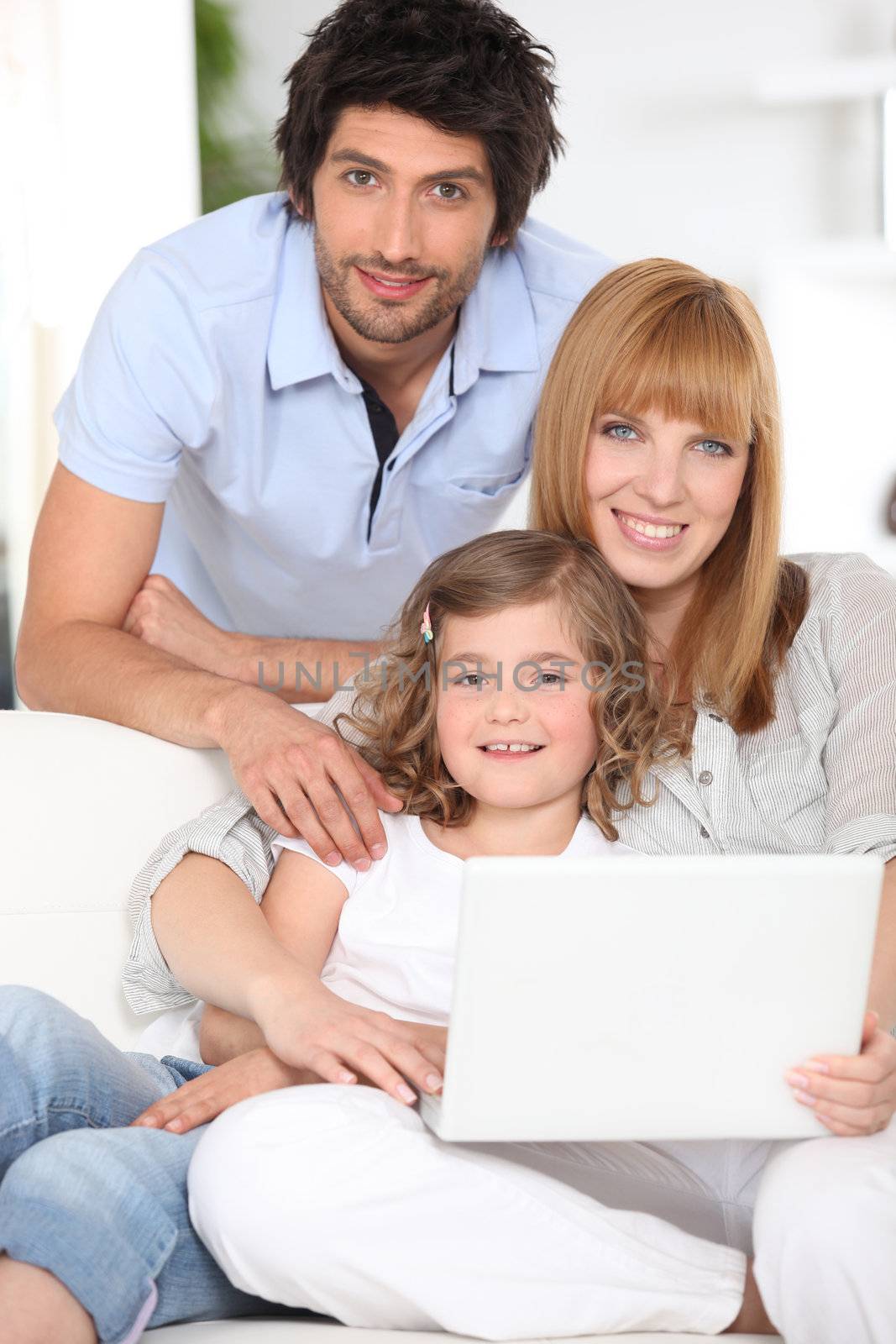 Parents and daughter with laptop computer