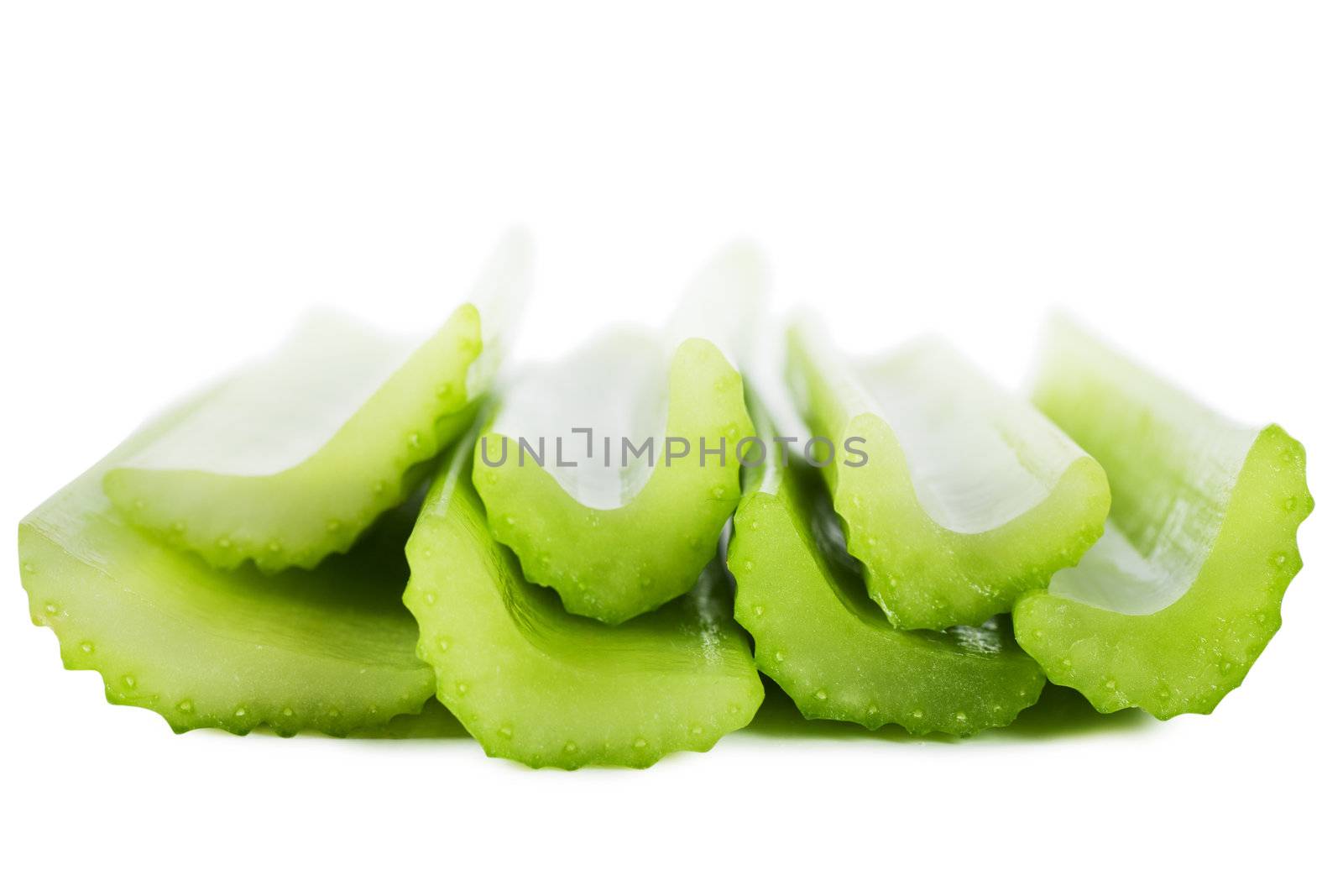 Fresh green stems of celery over white background