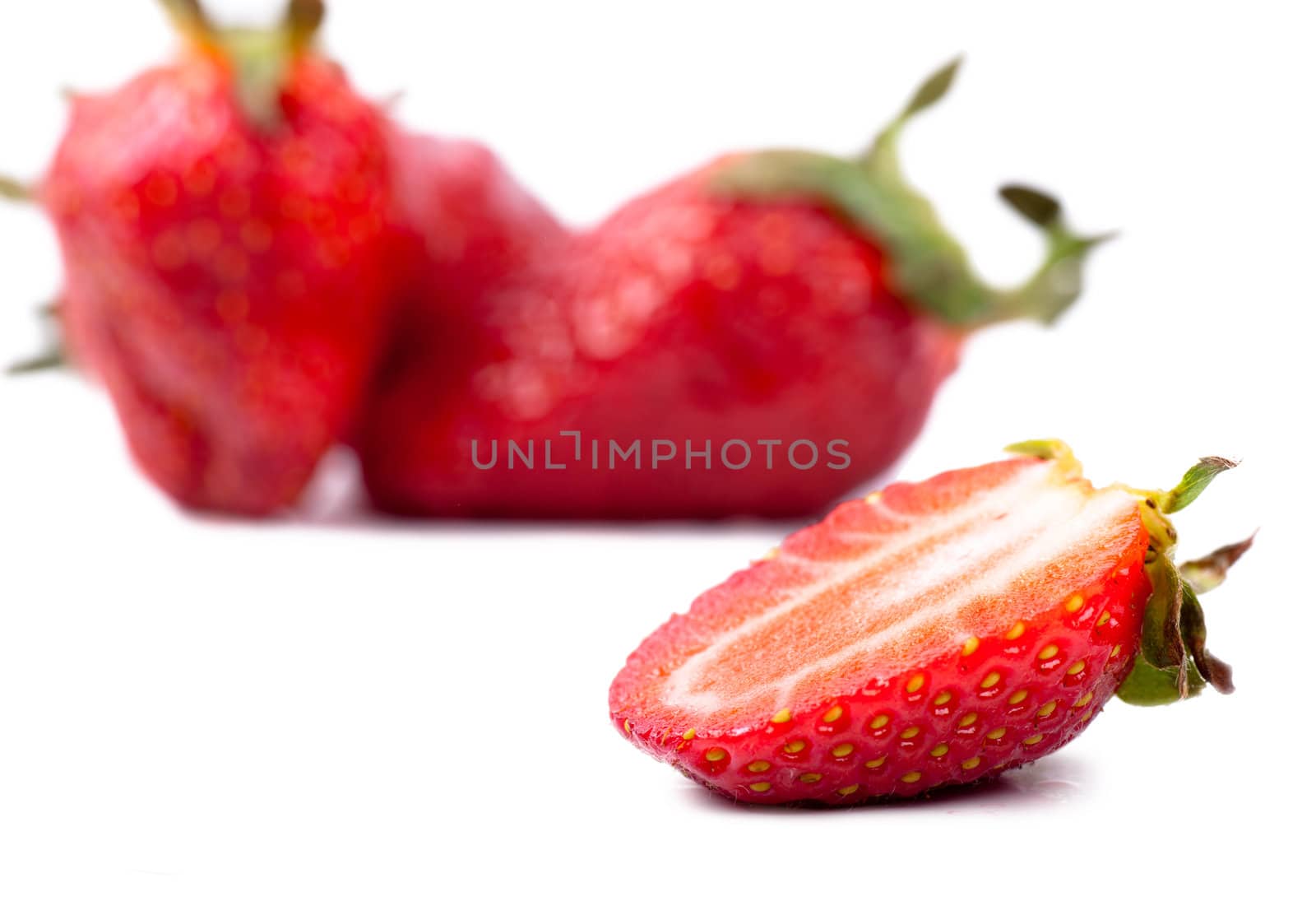 Macro view of fresh strawberries over white background