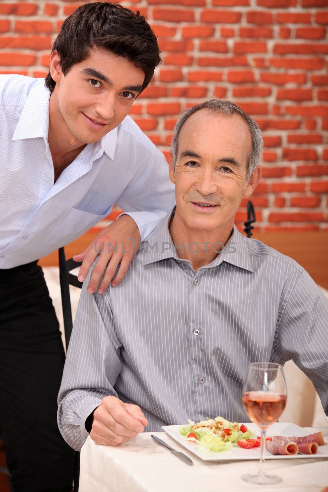 Grandfather with grandson at restaurant