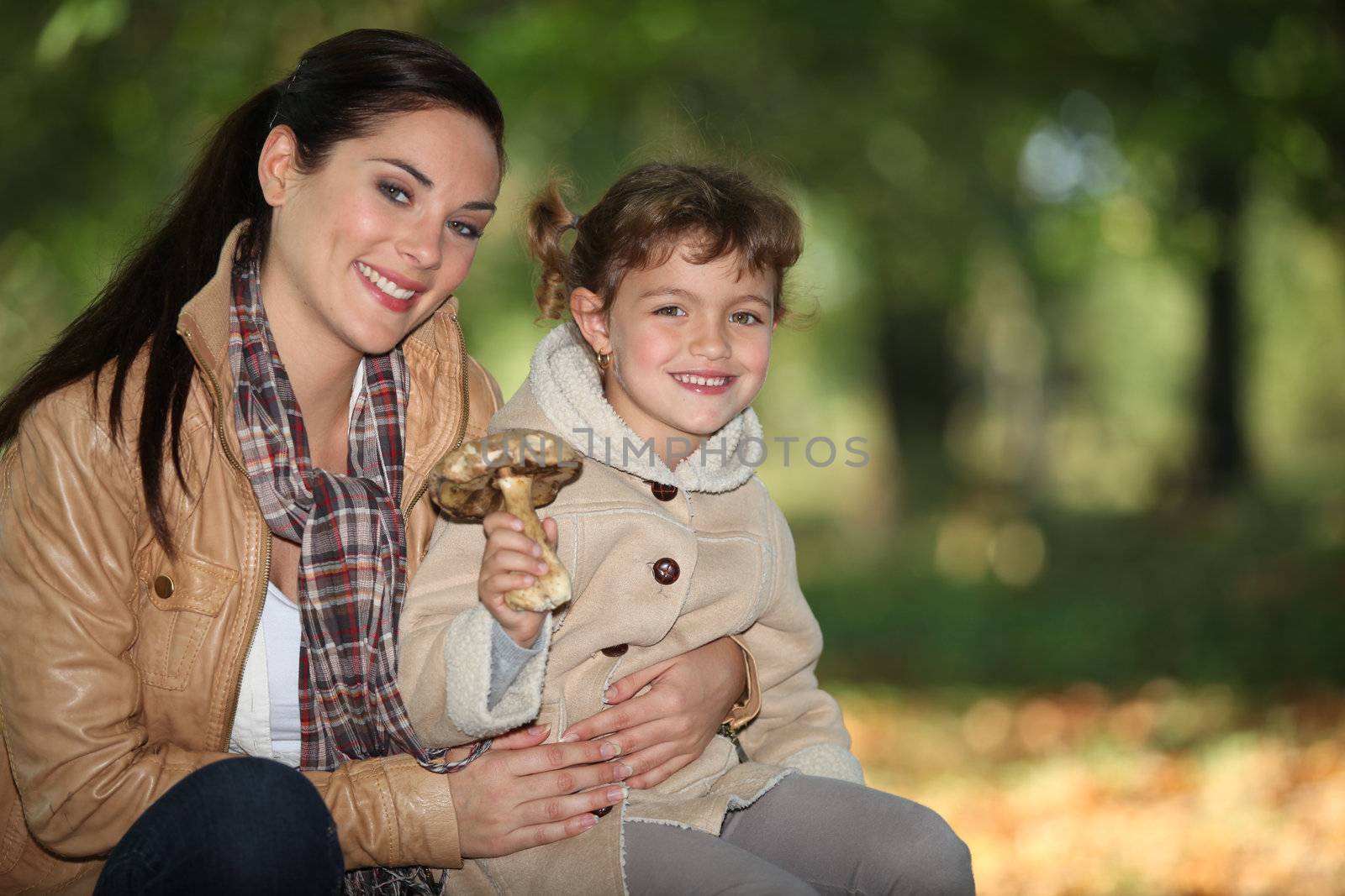 Mother and daughter gathering mushroom