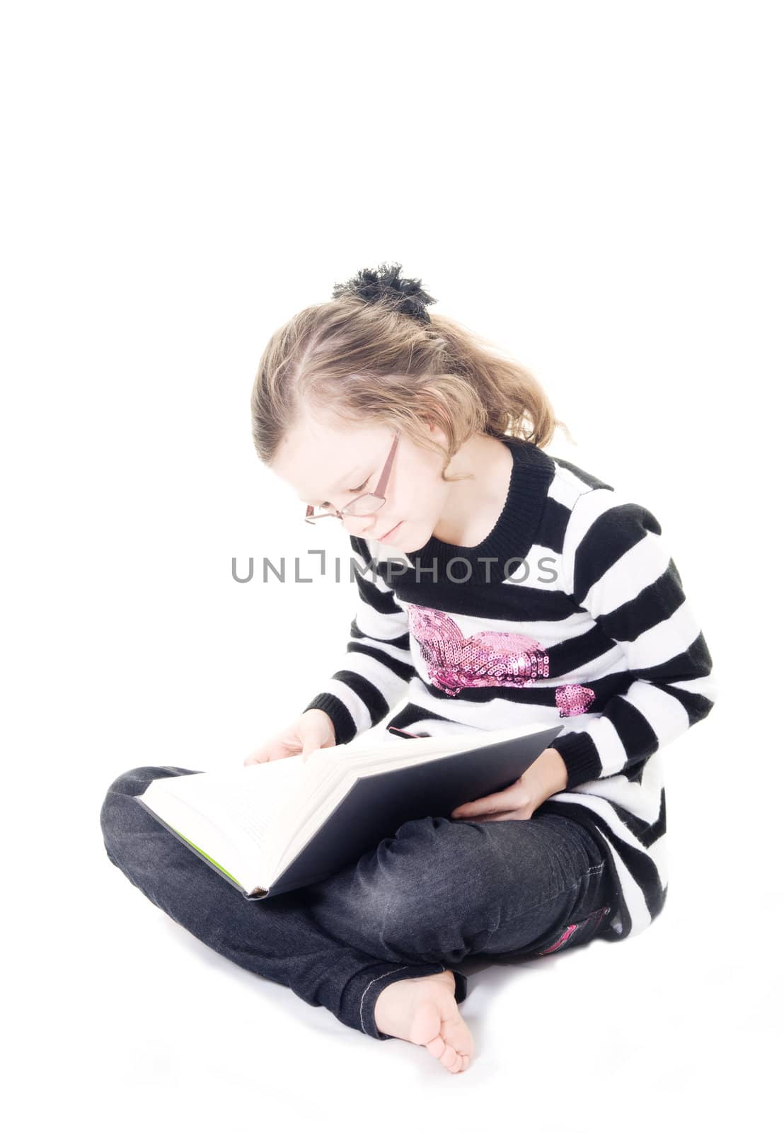 young girl reading a book isolated on white