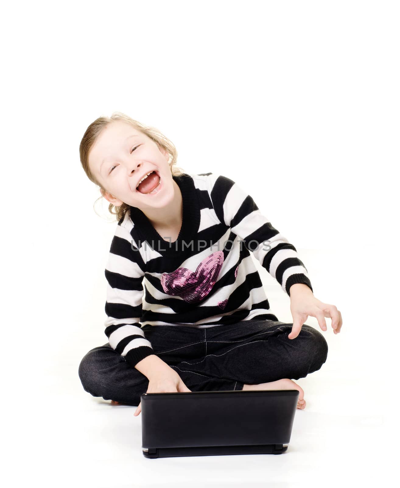 young girl happily using a computer laughing isolated on white