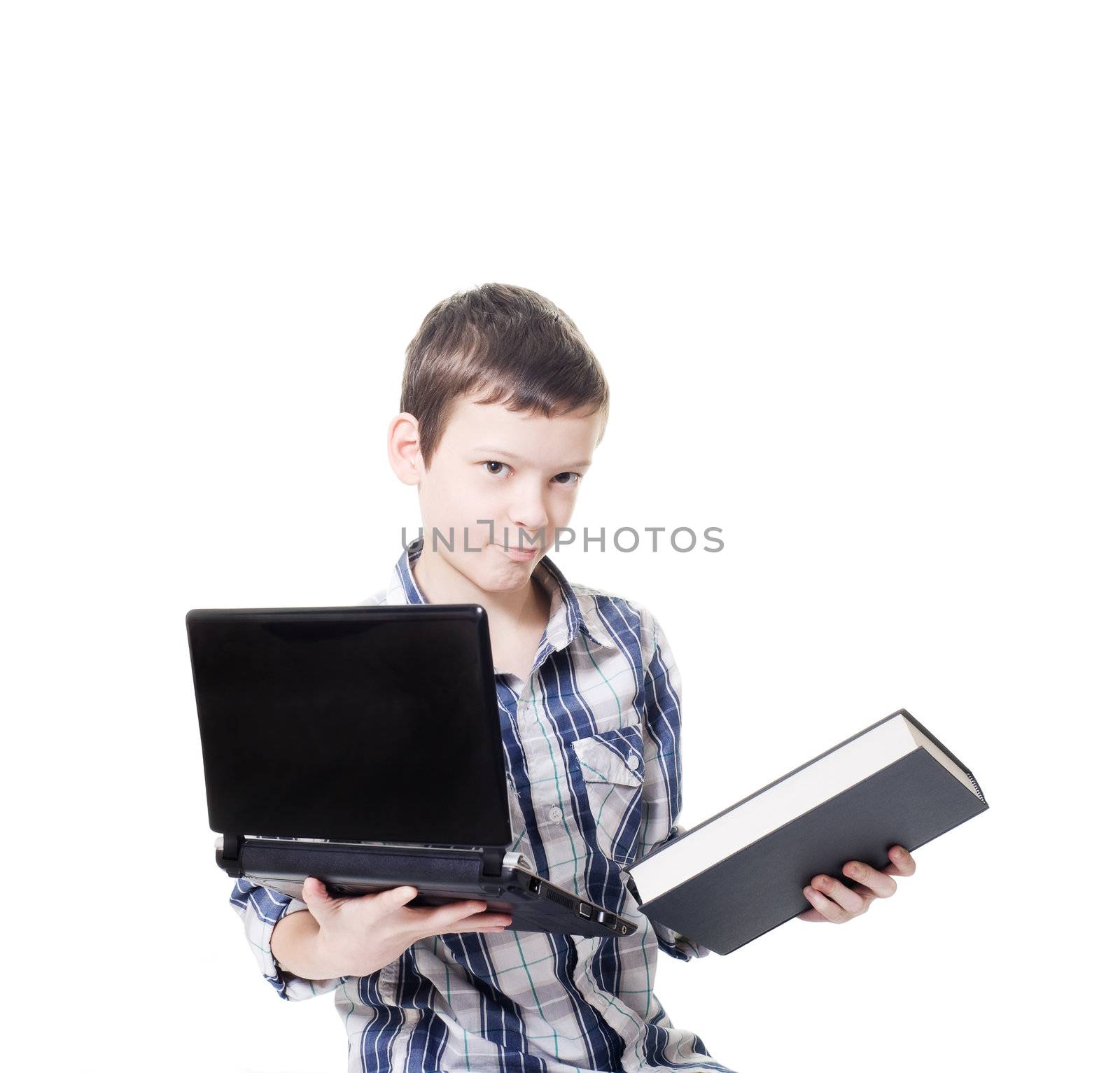 young boy holding a computer and a book