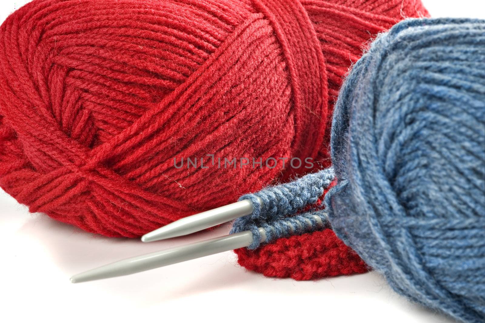 Woolen thread and knitting needle. Needlework accessories on white background.