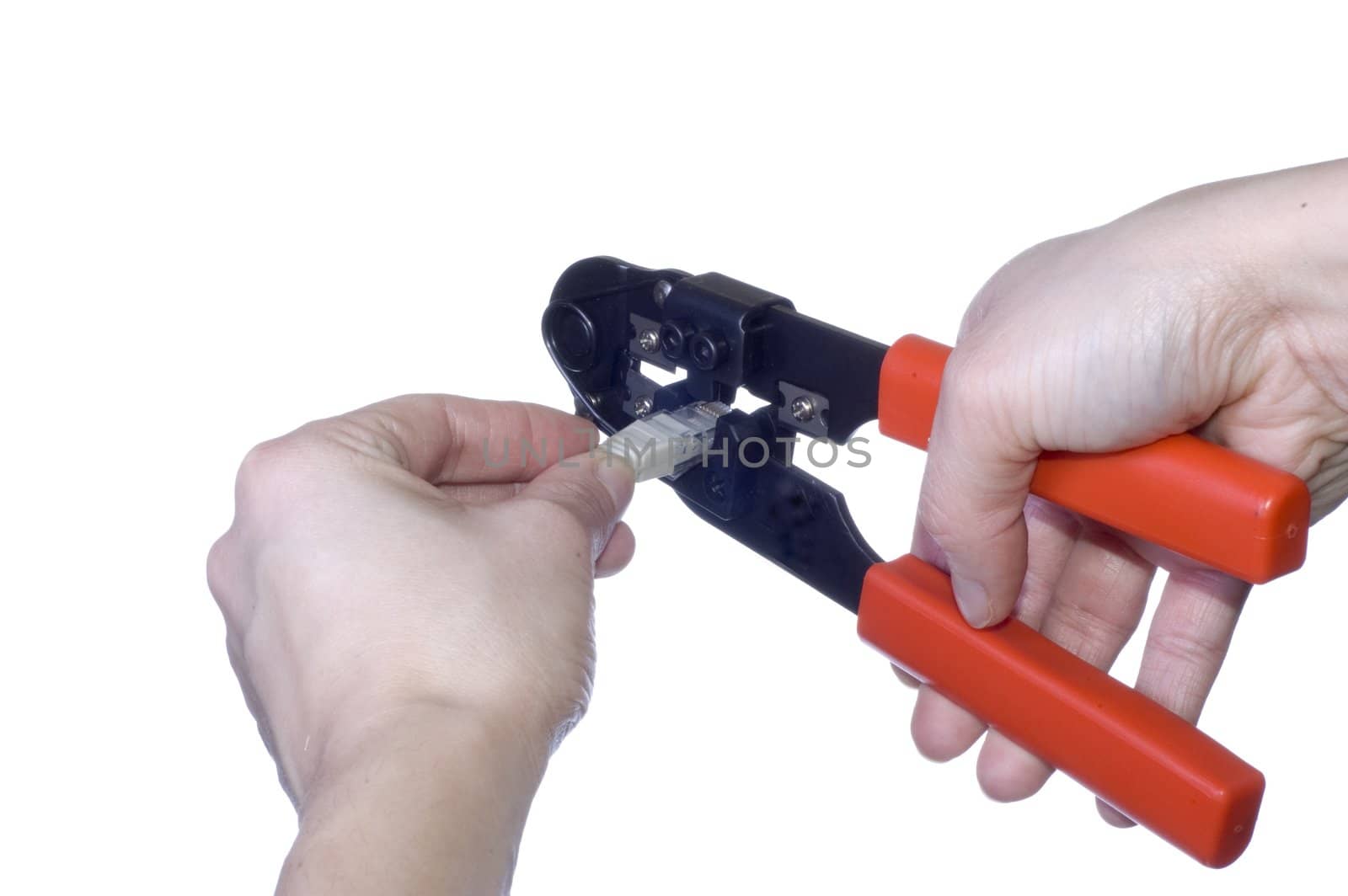 Woman hand keeps wire cable crimper on white background