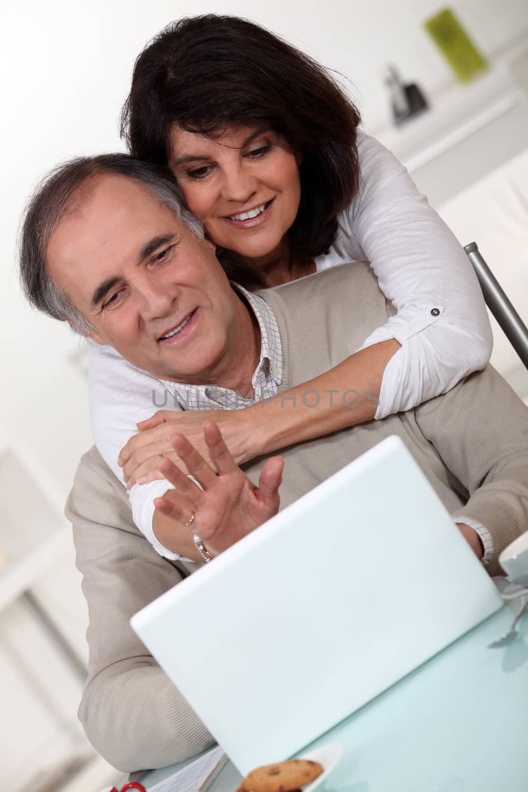 Couple in front of a laptop by phovoir