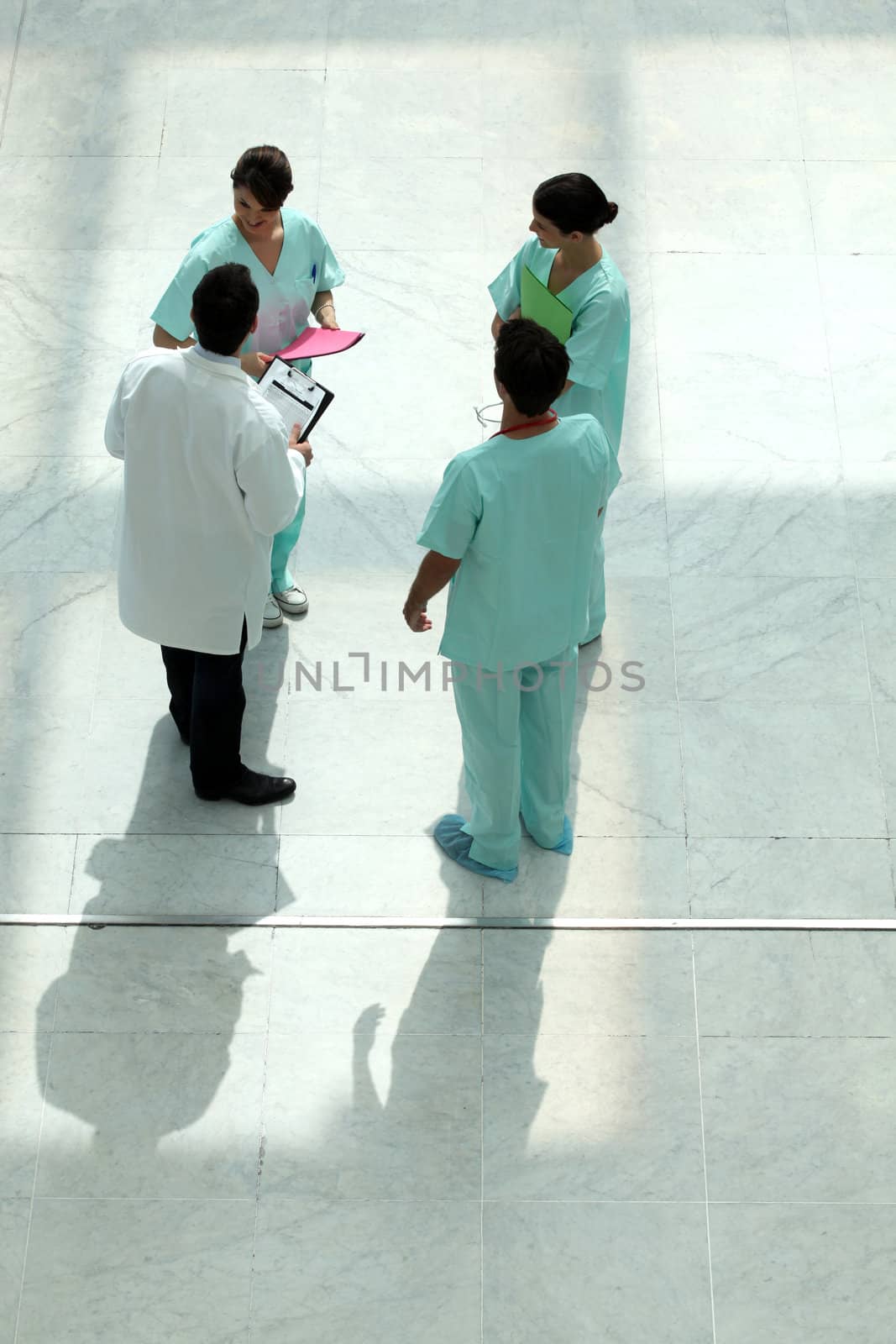 High angle view of a medical team chatting in an atrium by phovoir