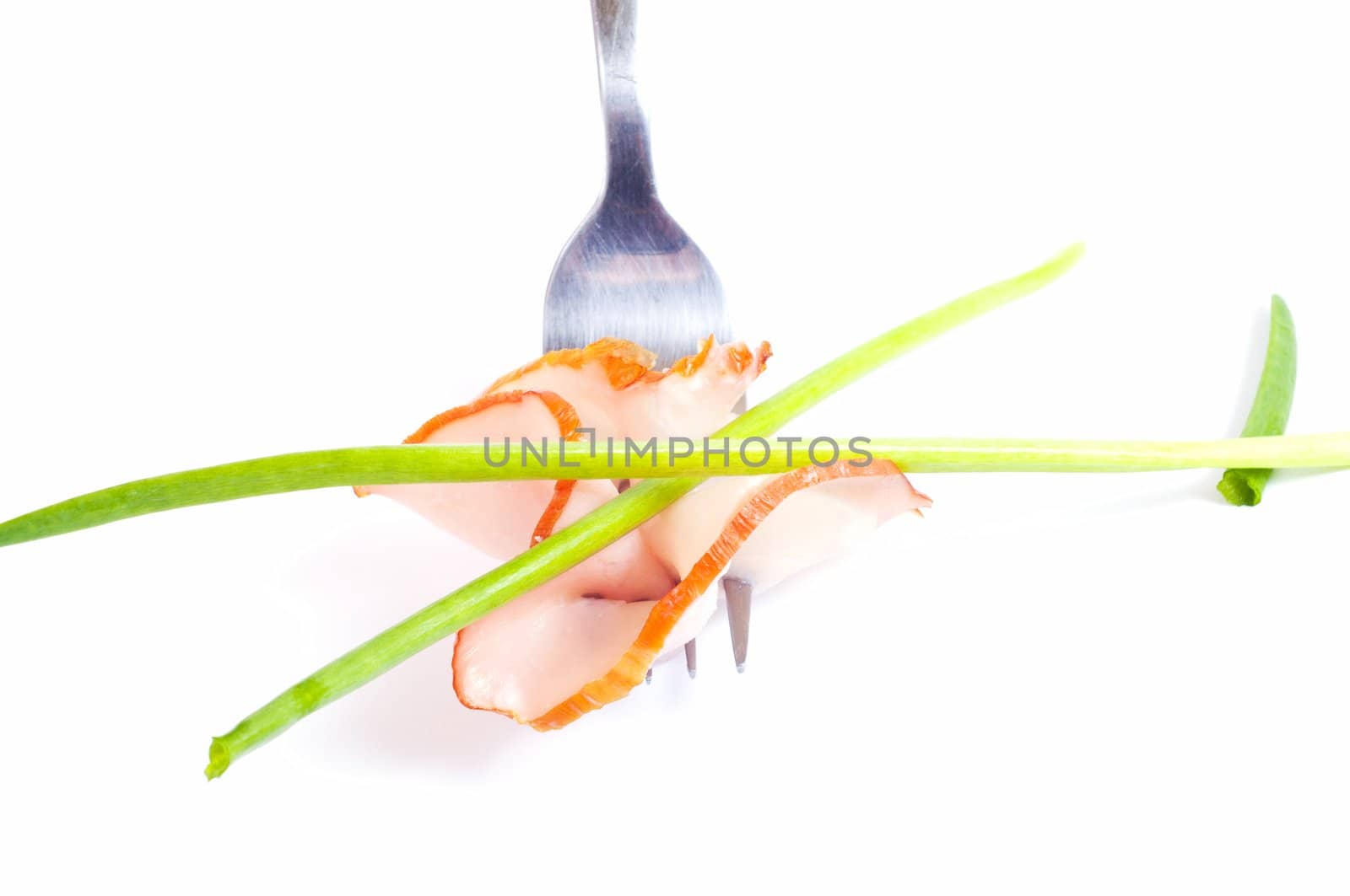 delicious sausage on a fork on white background