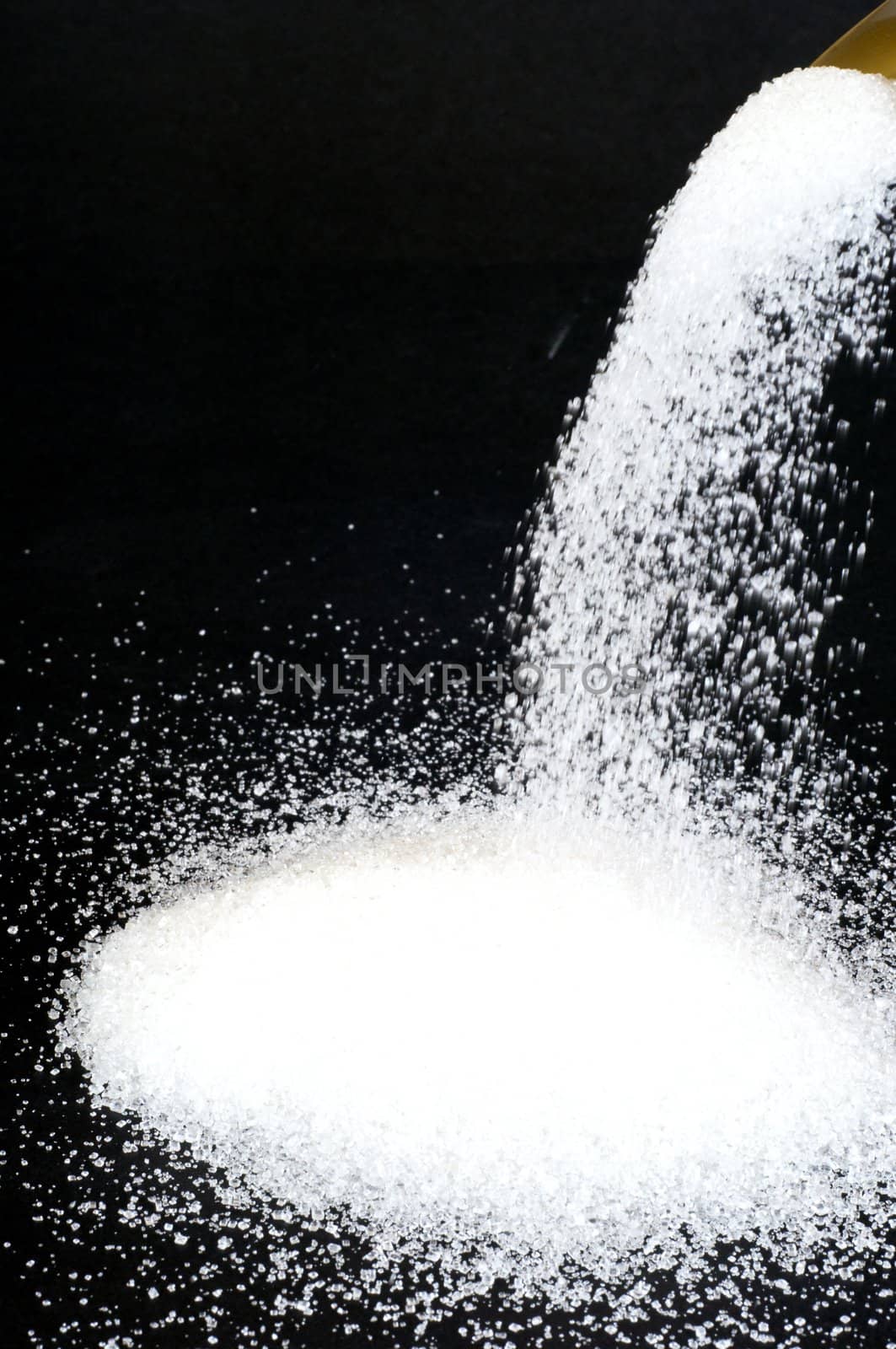Sugar poured on a black background