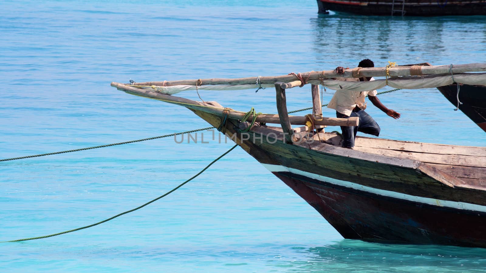 A fisherman and his boat on a quiet sunny day