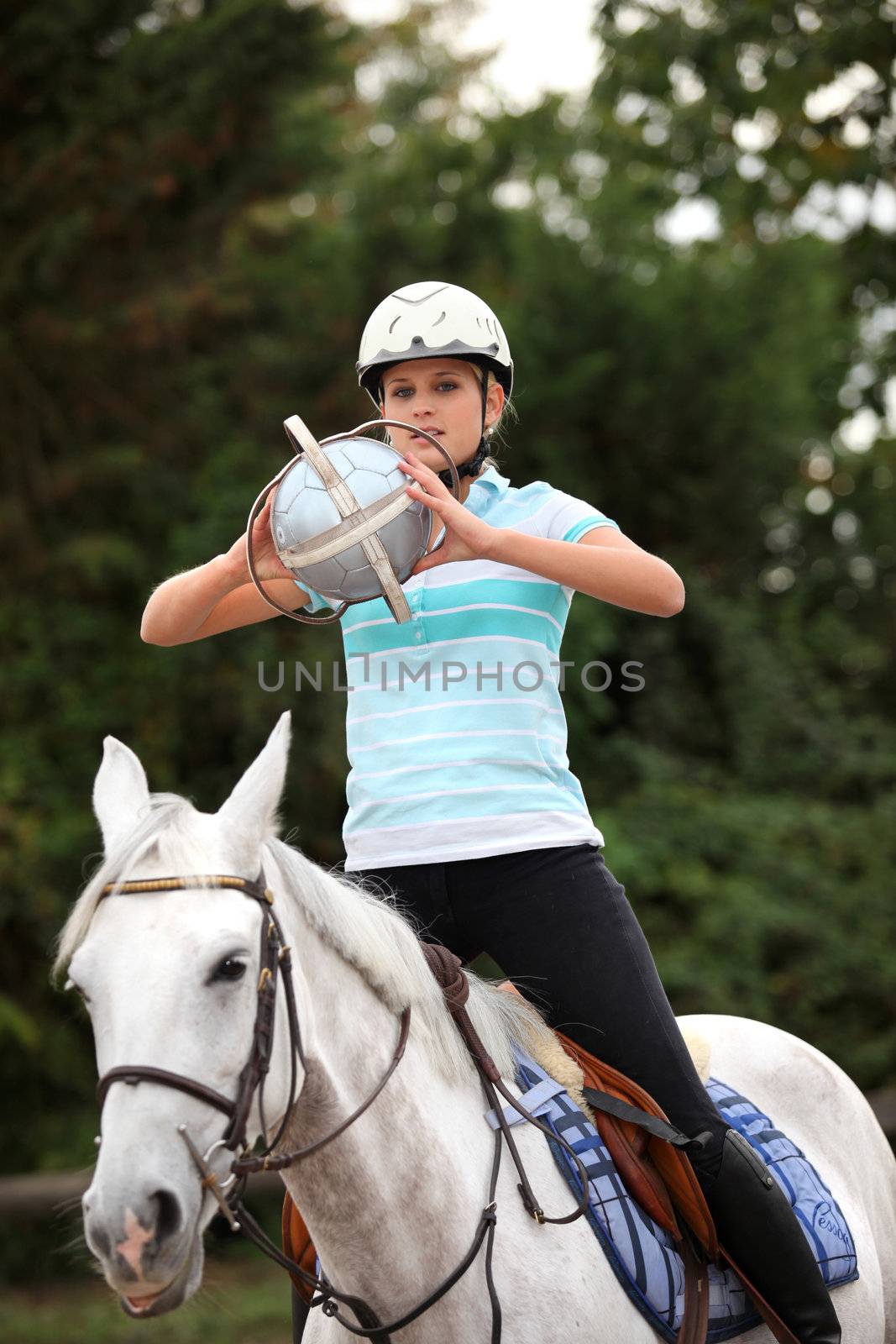 young woman playing horse-ball by phovoir