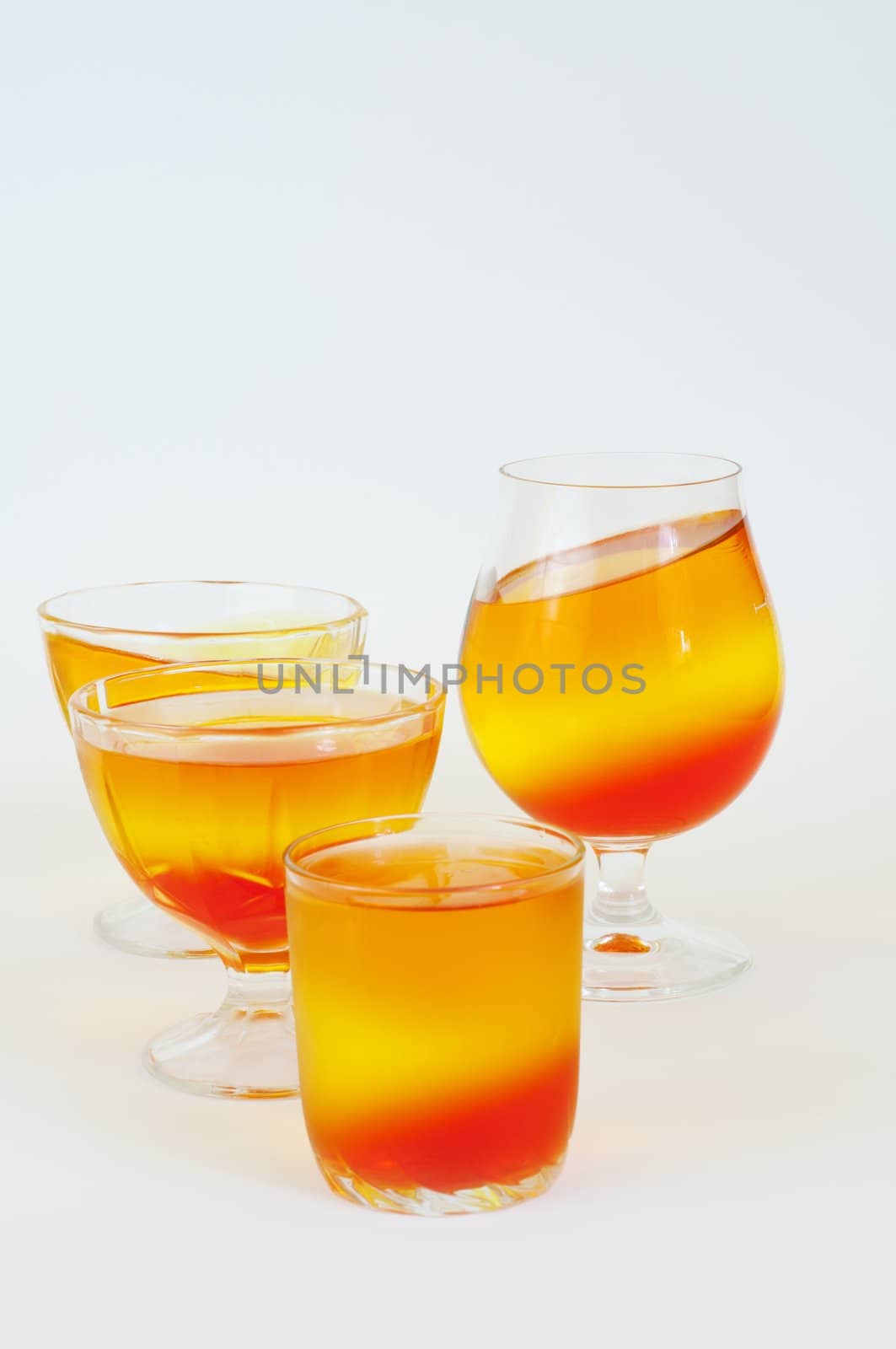 tricolor jelly in a glass on a white background