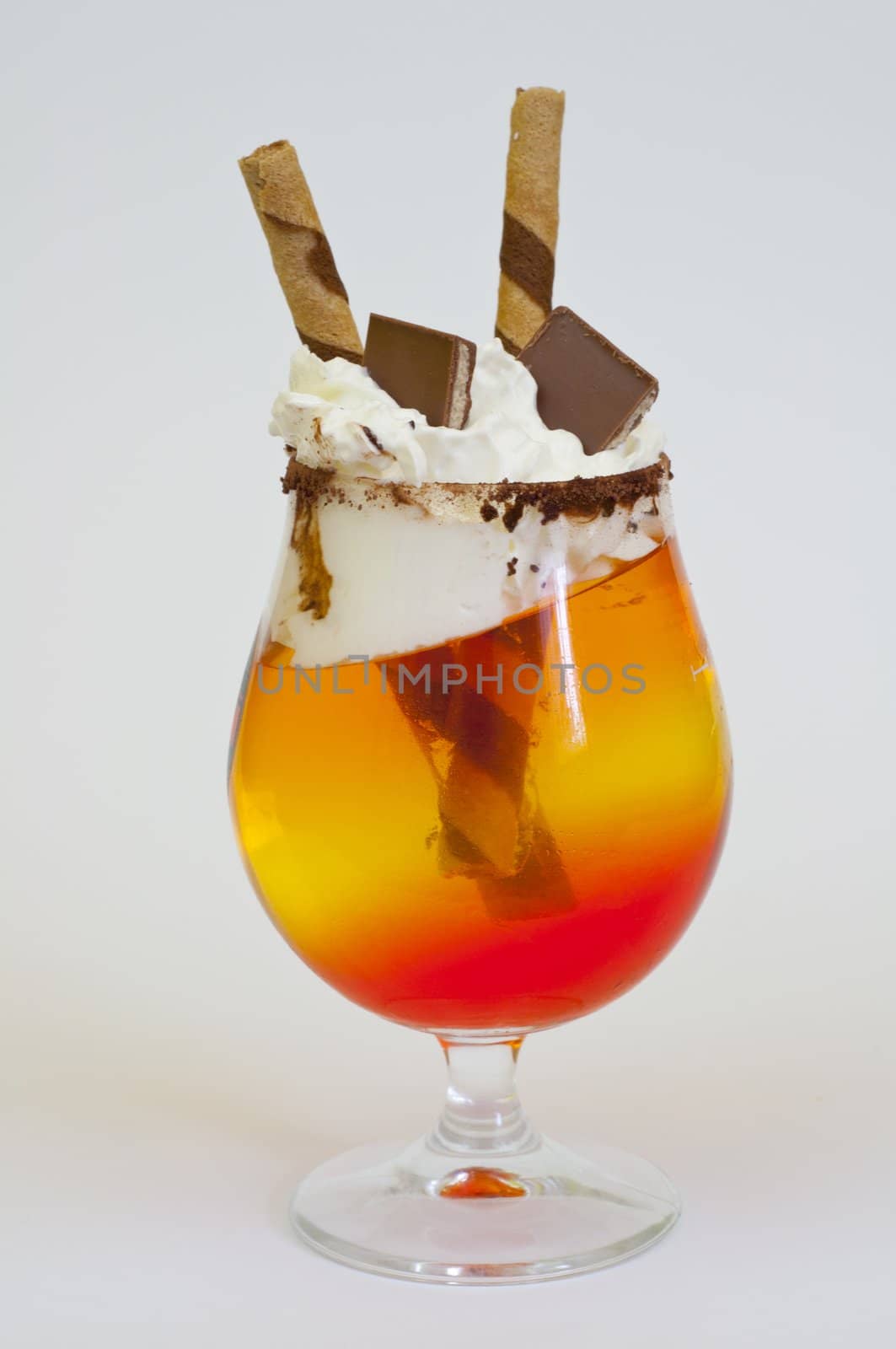 tricolor jelly in a glass on a white background