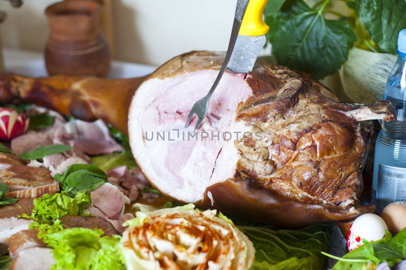 a woman cuts off a chunk of ham