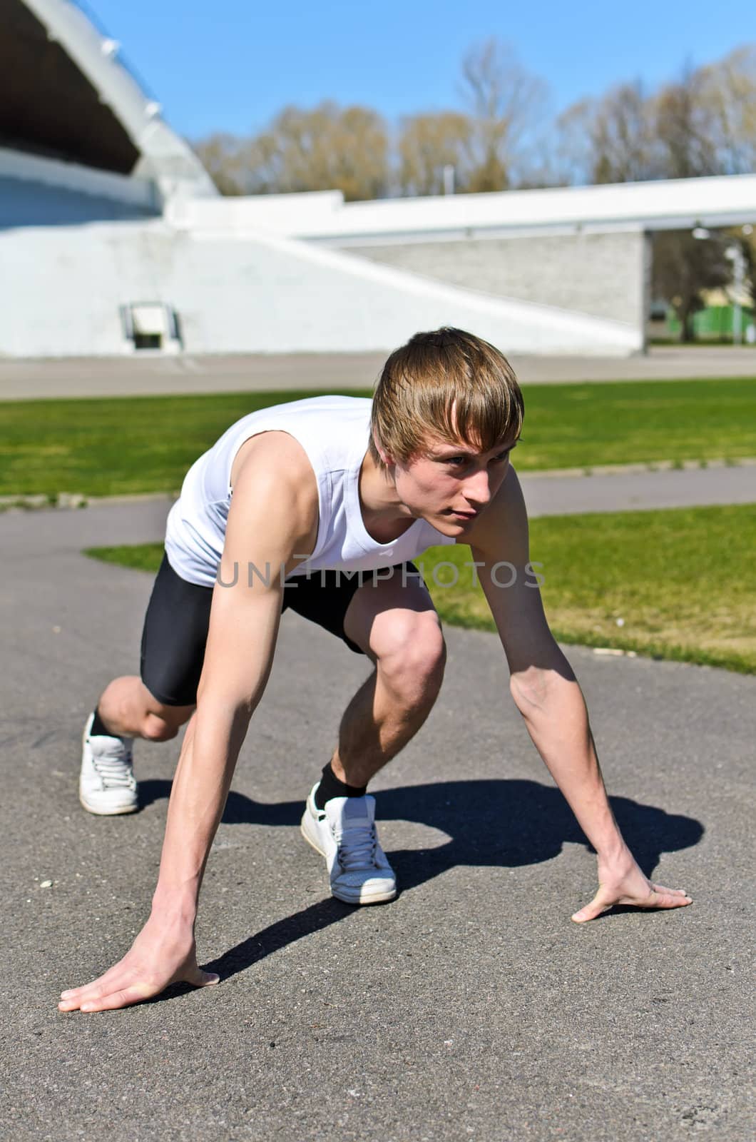 Young athletic man ready to run.