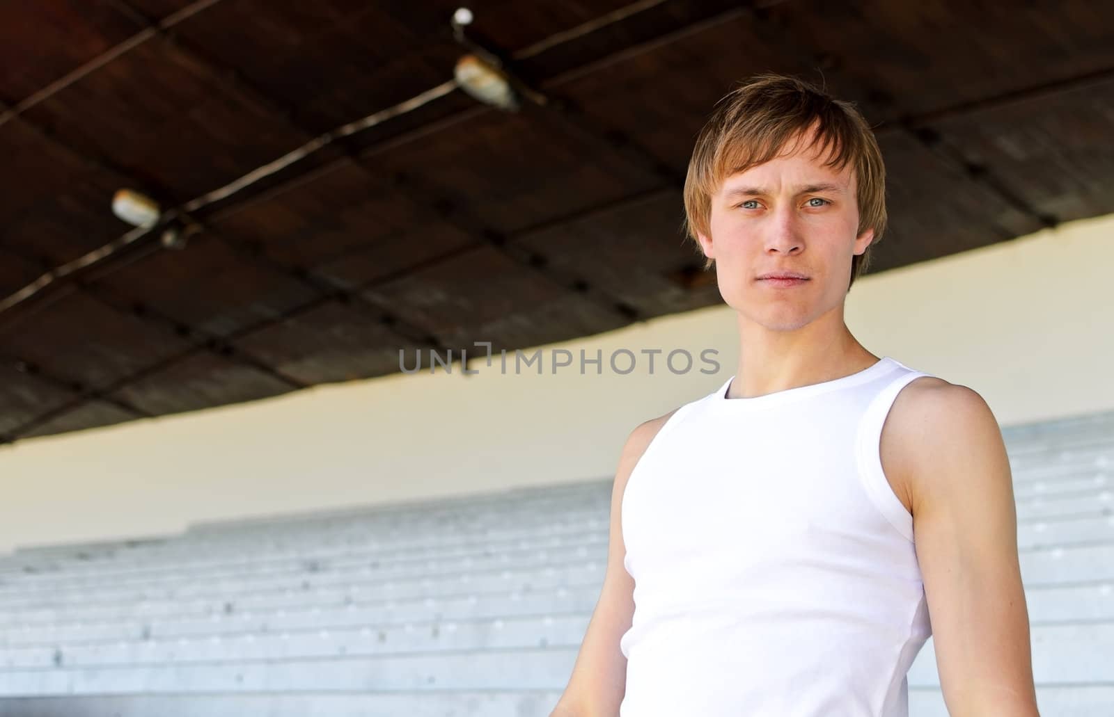 Portrait of athletic male against empty sport stadium