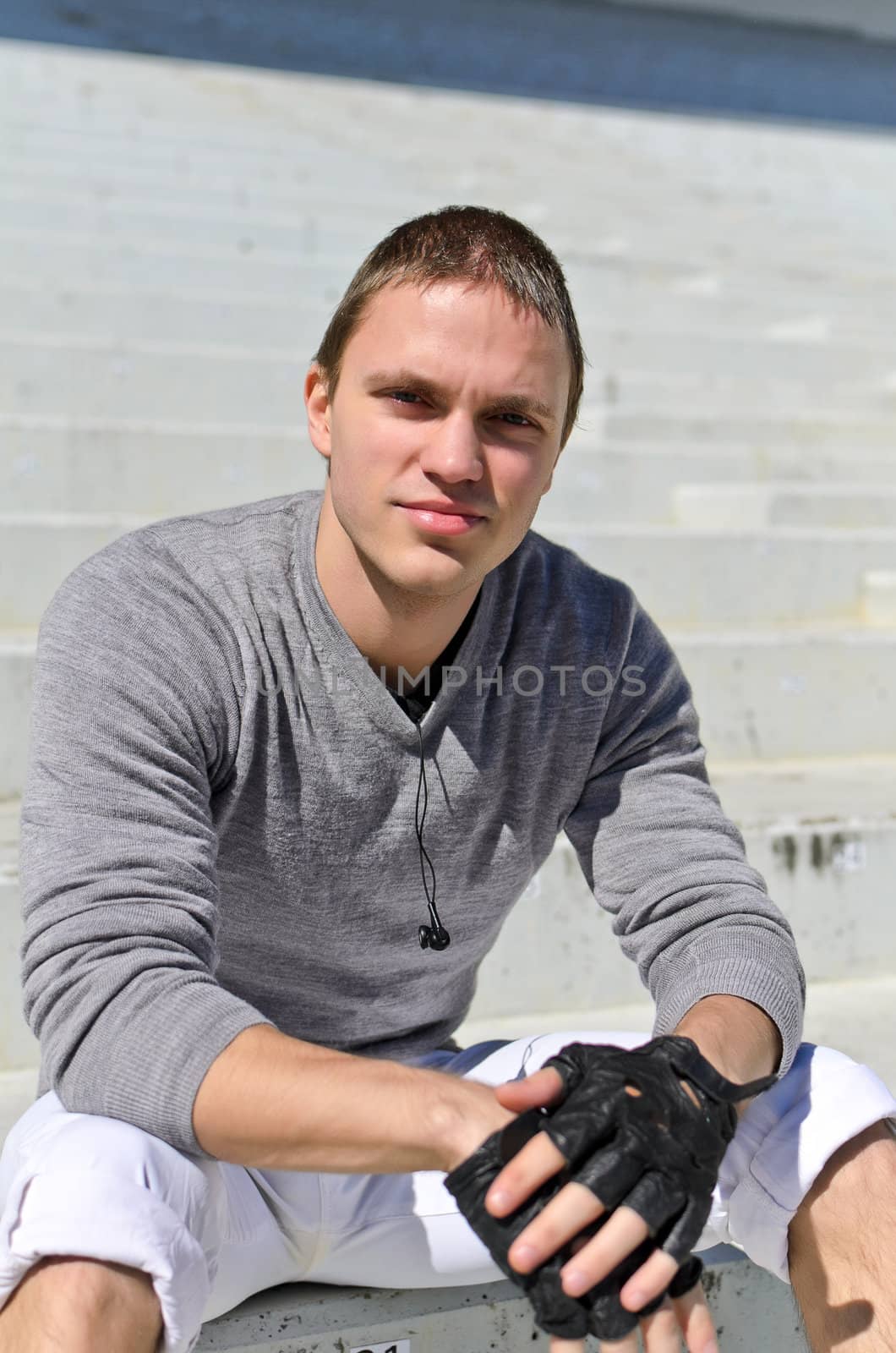 Young athletic guy in an empty stadium