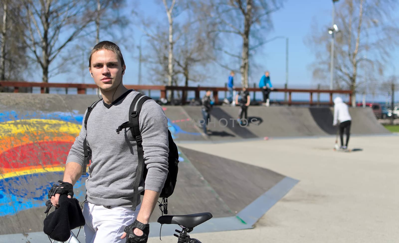Portrait of BMX bicycle rider on urban skatepark background