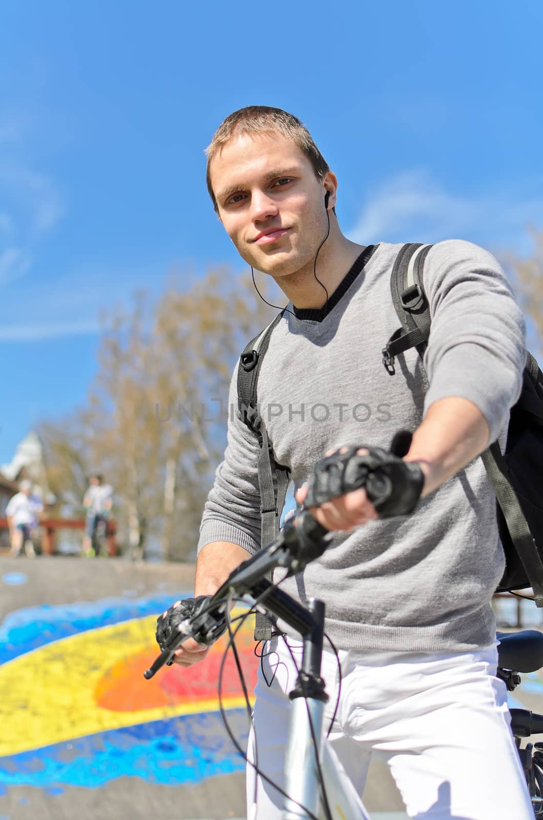 Portrait of BMX bicycle rider on urban skatepark background