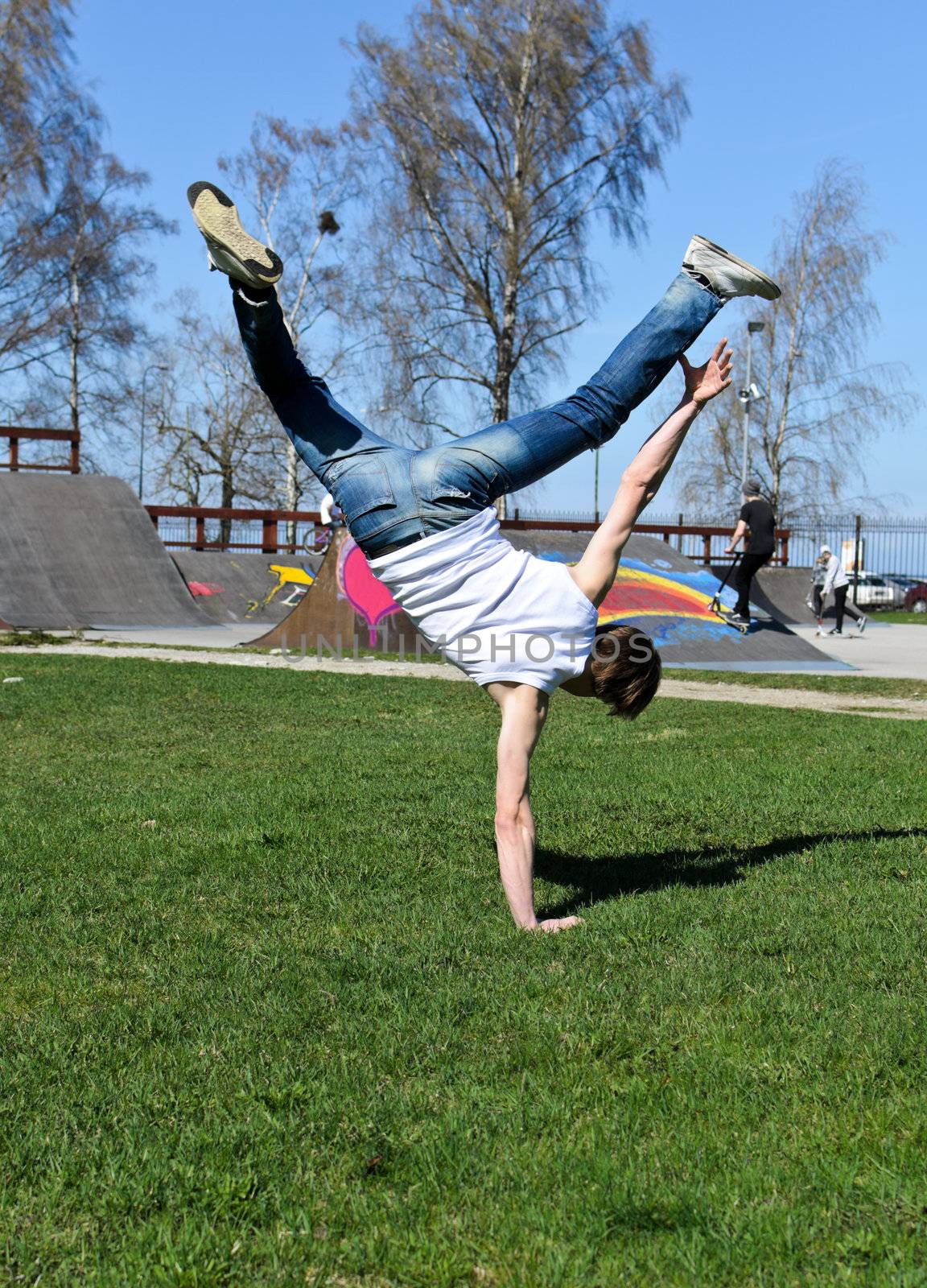 Breakdancer doing a flip on the grass.
