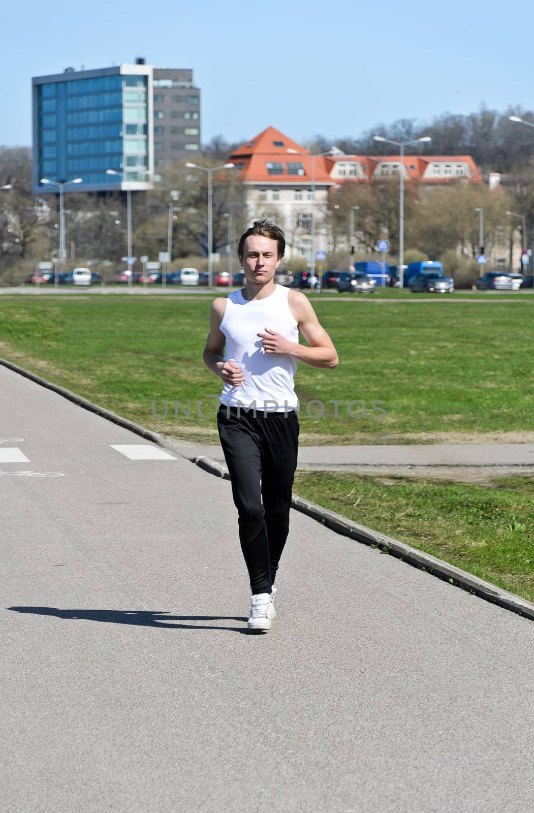 Athletic young male running around the city