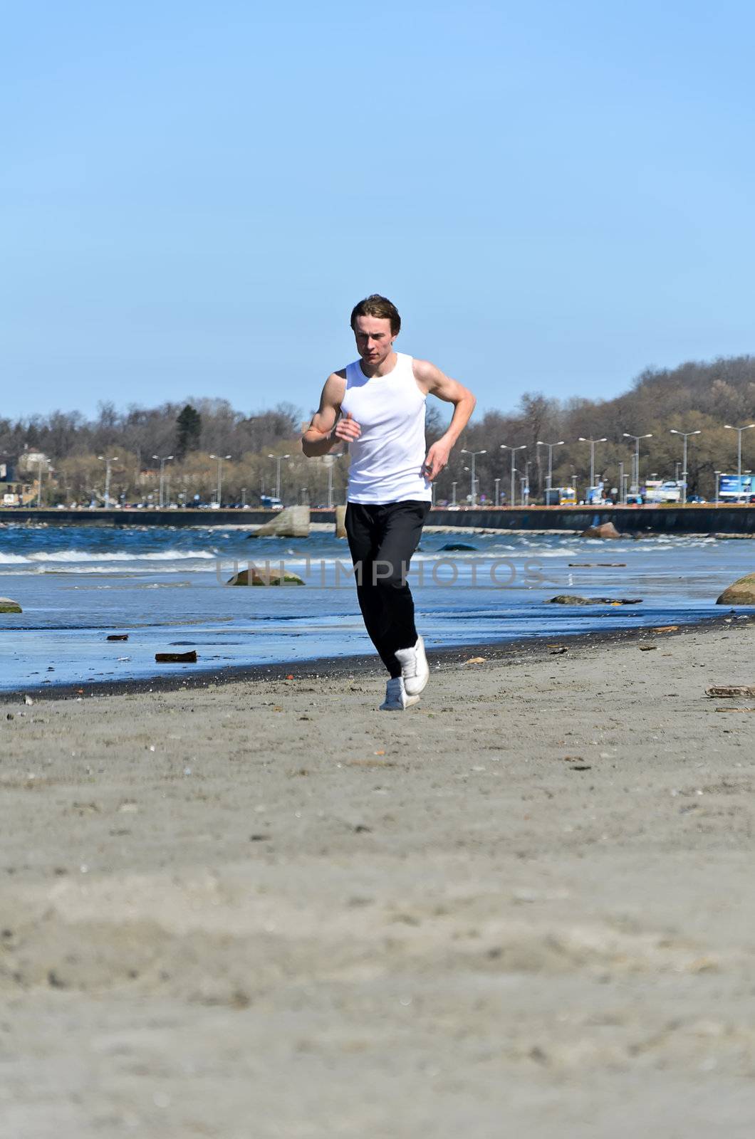 Athletic young male running on the beach