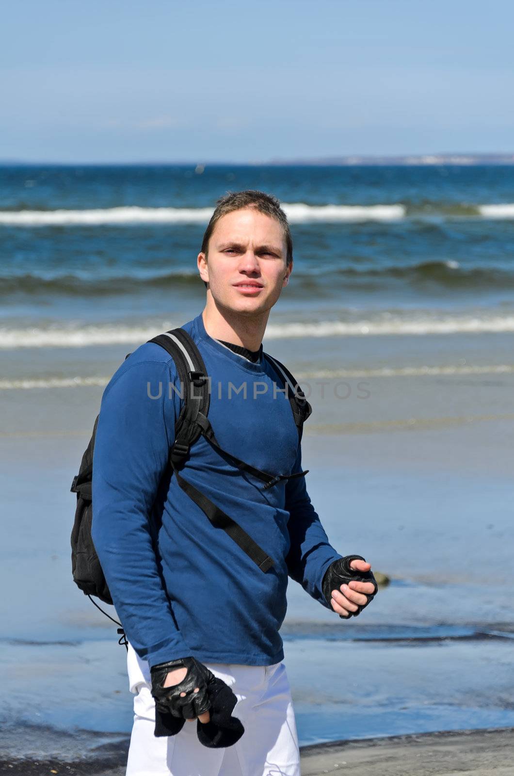 Handsome male tourist lost his way near the ocean