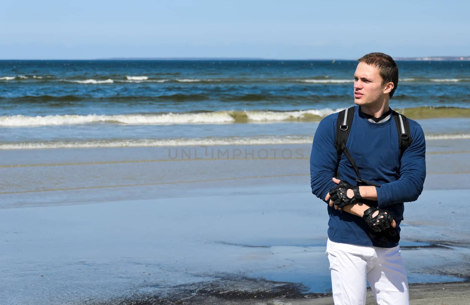 Handsome male tourist lost his way near the ocean