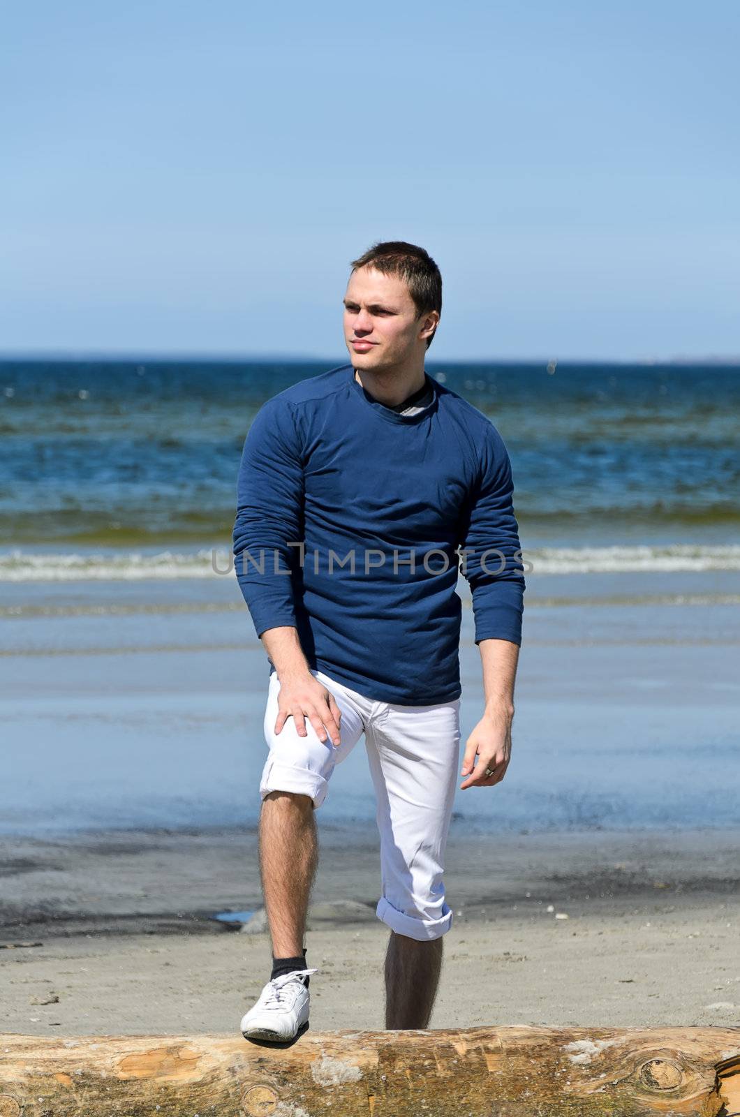 Young male standing on the beach