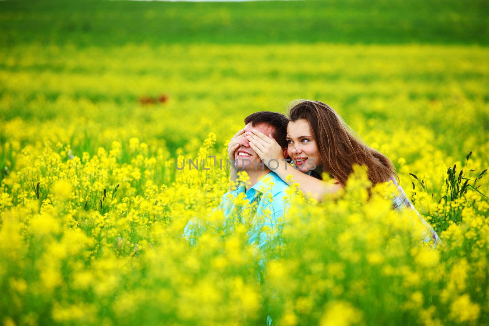 lovers hug on yellow flower field
