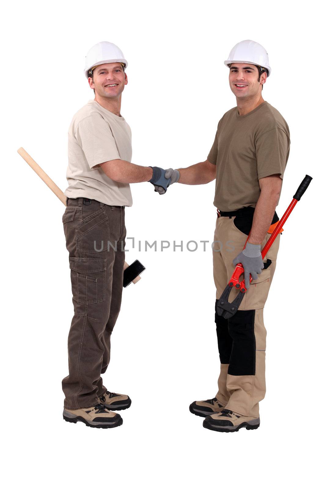 Tradesmen shaking hands by phovoir