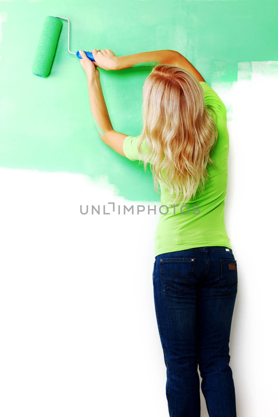 woman paints the wall brush