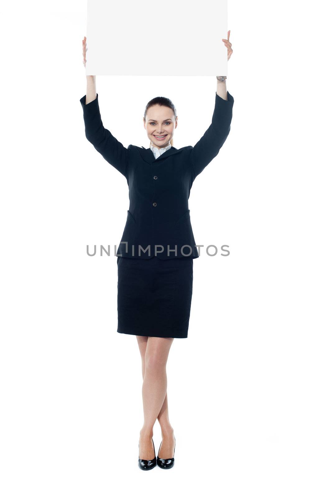 Full length portrait of a happy young businesswoman holding a blank signboard isolated on white background