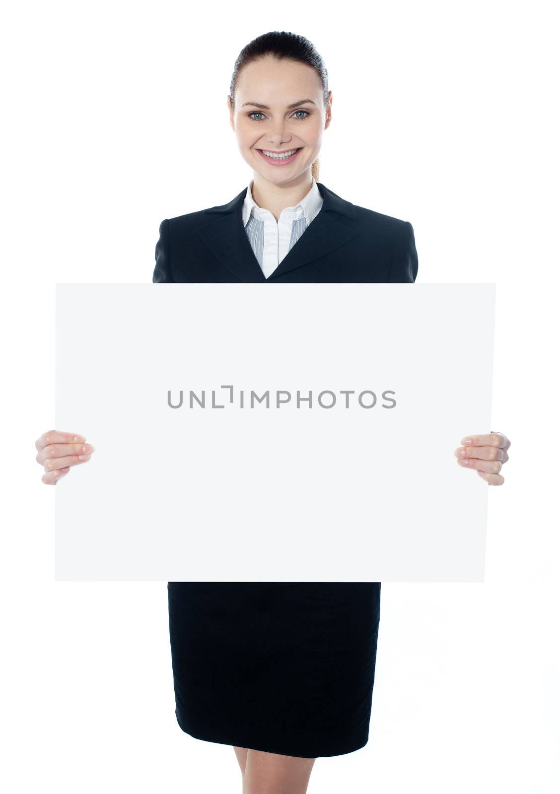 Businesswoman holding a blank poster against white background, smiling