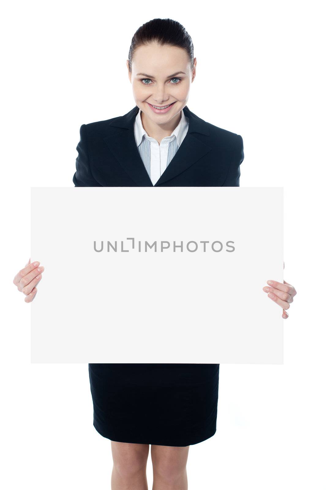 Female executive showing blank billboard to camera by stockyimages