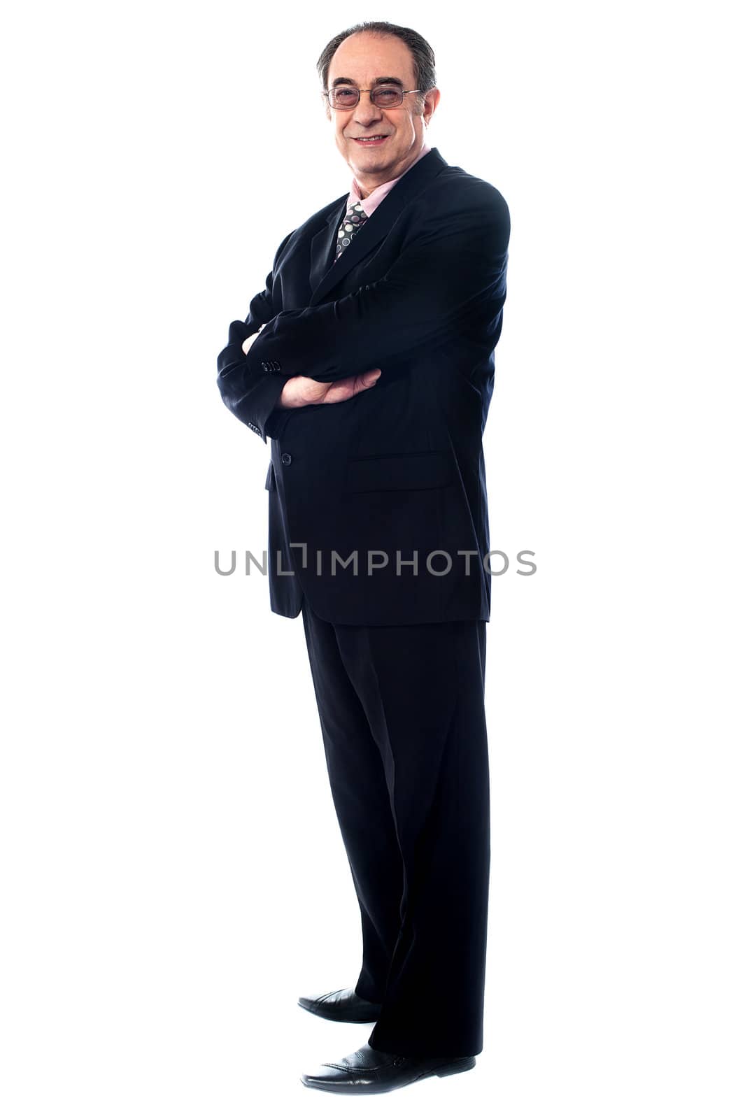 Aged company manager posing with folded arms by stockyimages