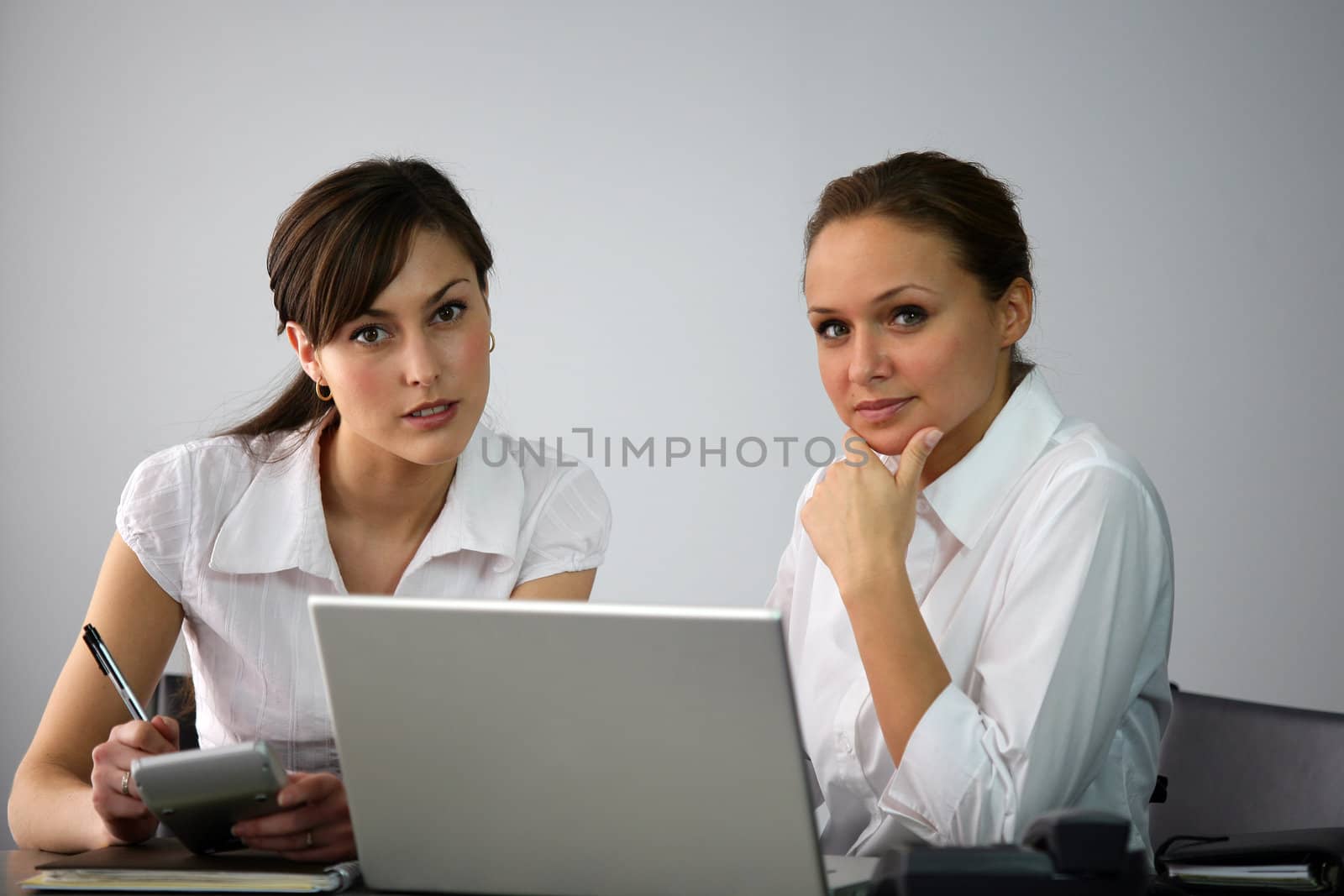 Businesswomen collaborating by phovoir