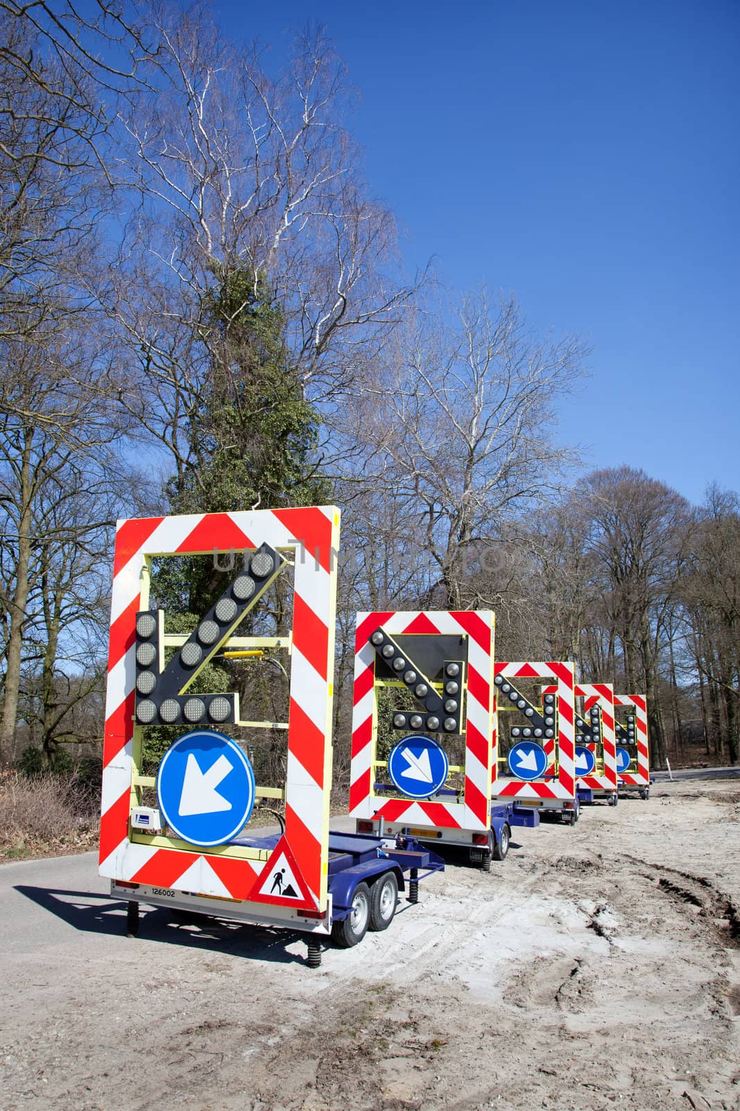 row of traffic warning signs on wheels