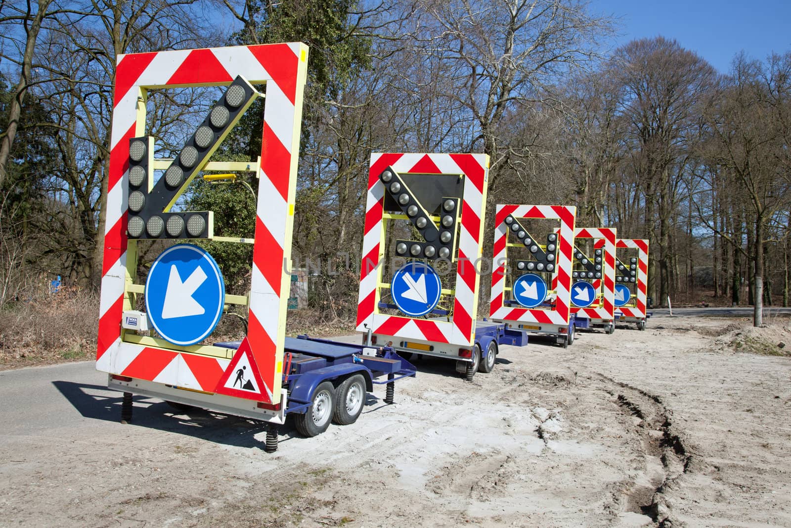 row of traffic warning signs and arrows on trailers
