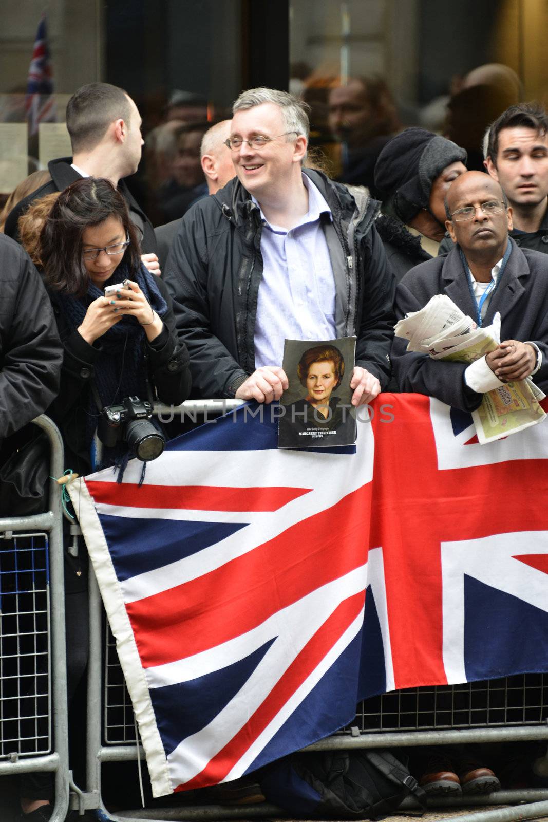 London, UK. April 17th, 2013. Man holding a portrait of Baroness Thatcher  along the Procession route.