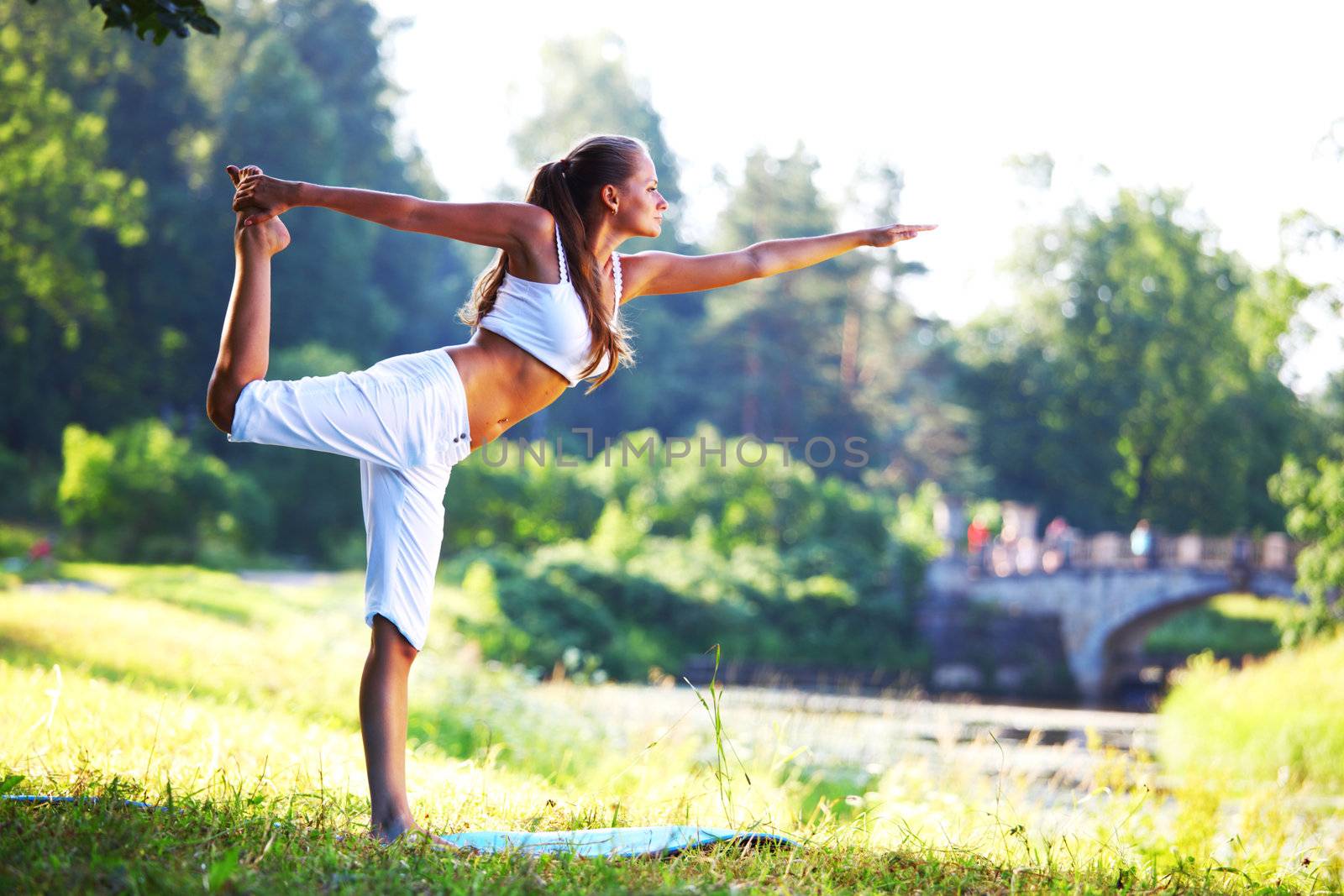 yoga woman on green park background