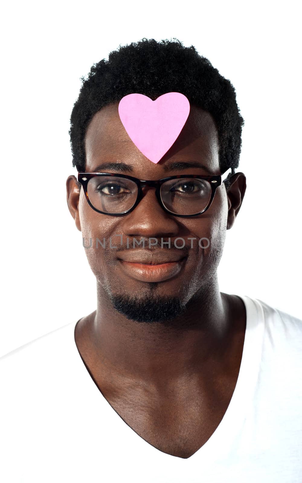 Closeup of an african man with pink paper heart on forehead by stockyimages