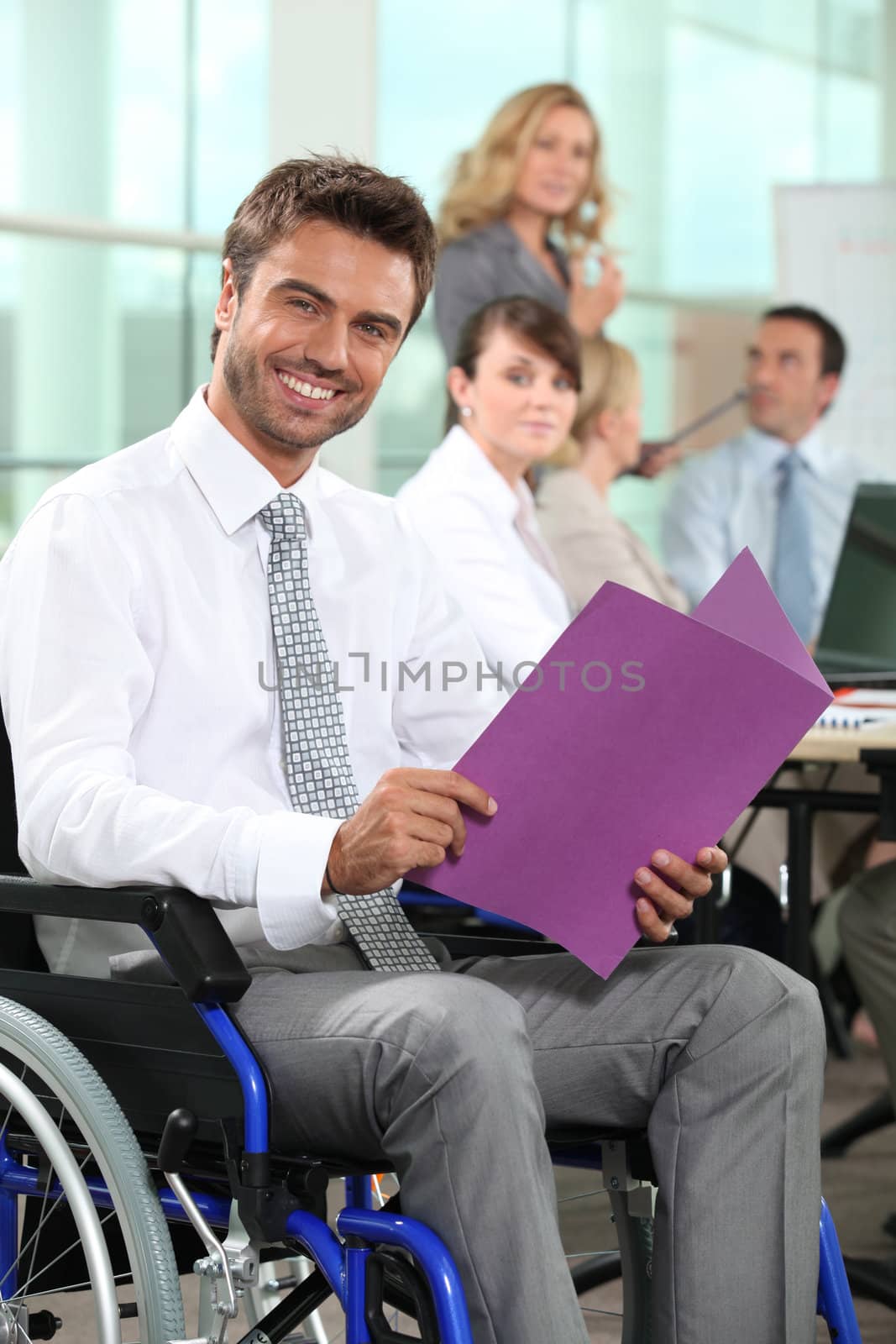 Man in wheelchair looking at notes