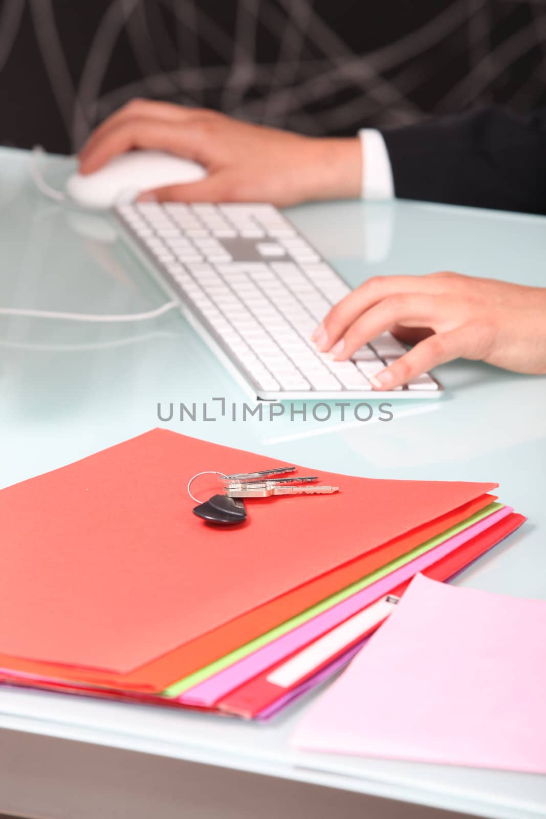 Businesswoman using a keyboard and mouse by phovoir