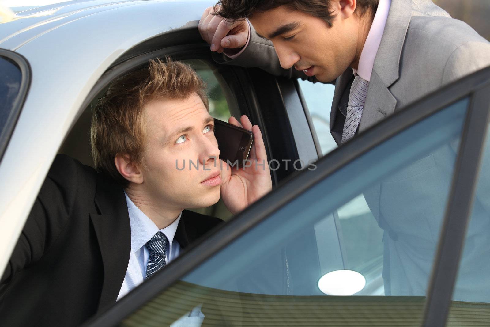 Businessmen talking before a meeting by phovoir