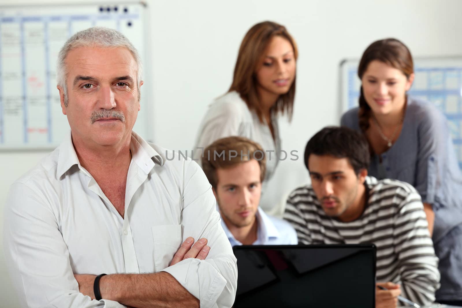 group of persons on a computer